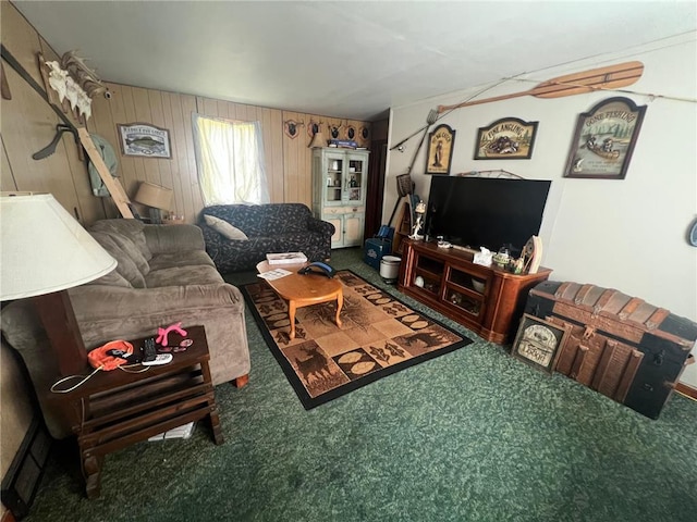 carpeted living room featuring wooden walls