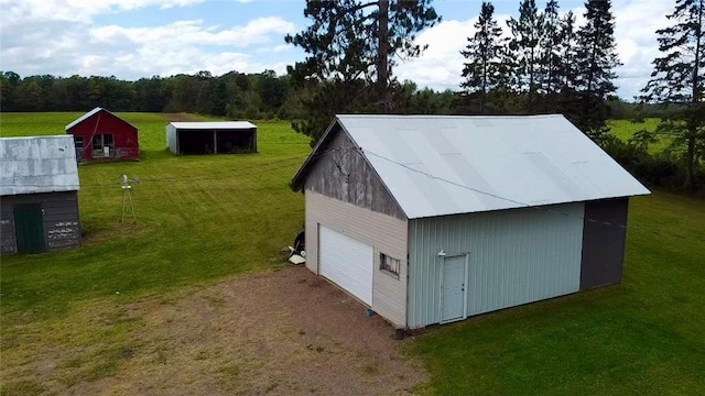 view of outbuilding featuring a lawn and a garage