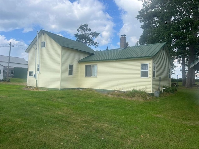 rear view of property featuring a lawn