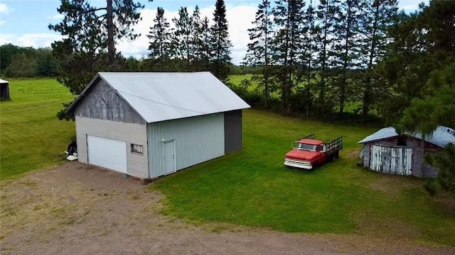 view of outbuilding featuring a garage and a lawn