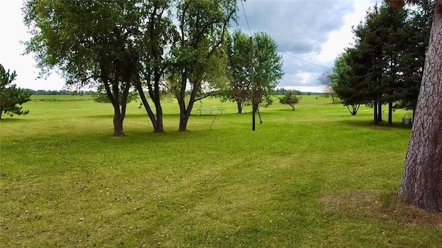 surrounding community featuring a lawn and a rural view