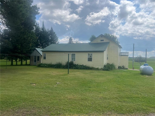 view of property exterior featuring a lawn