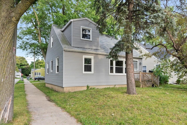 exterior space with a wooden deck and a lawn