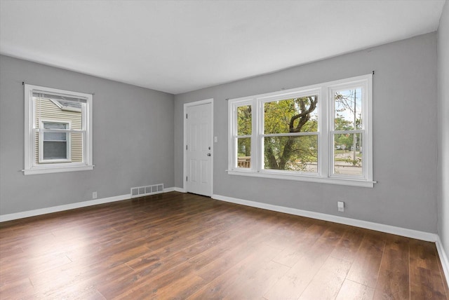 empty room featuring dark hardwood / wood-style flooring