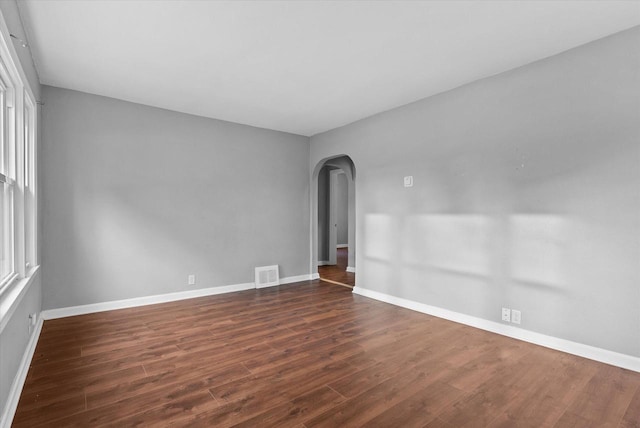 empty room featuring dark hardwood / wood-style flooring