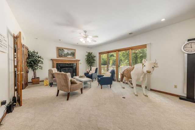 carpeted living area with ceiling fan, recessed lighting, baseboards, and a premium fireplace