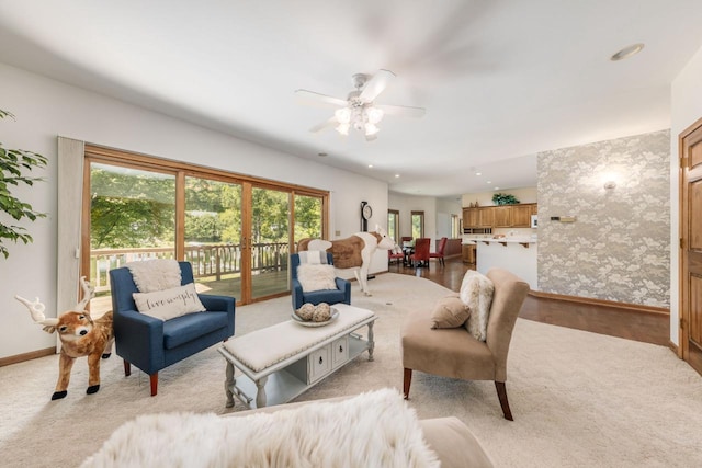 living area featuring a ceiling fan, light wood-style flooring, recessed lighting, and baseboards