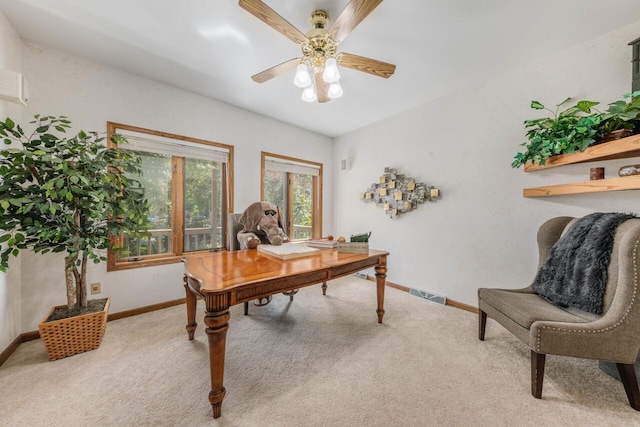 carpeted office featuring visible vents, a ceiling fan, and baseboards