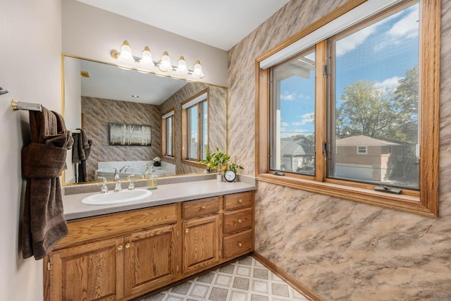 bathroom featuring tile patterned floors, vanity, and wallpapered walls