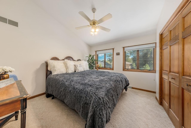 bedroom featuring vaulted ceiling, visible vents, baseboards, and light carpet