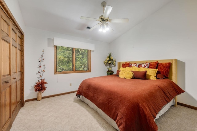 bedroom with visible vents, baseboards, lofted ceiling, ceiling fan, and light carpet