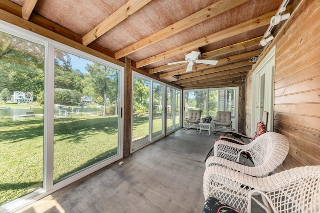 sunroom with beam ceiling and a ceiling fan