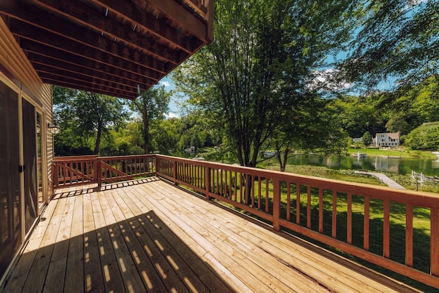 wooden deck featuring a water view