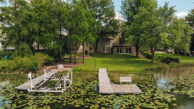 dock area with a water view and a lawn