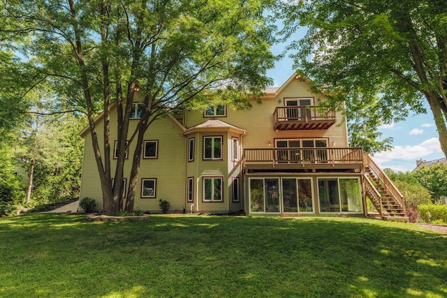 back of property with a lawn, stairs, and a balcony