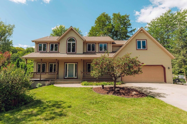 colonial house with a porch, concrete driveway, and a front yard