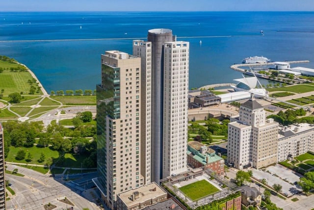 birds eye view of property with a water view and a view of city