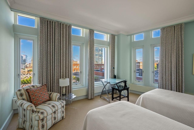 bedroom featuring crown molding, light colored carpet, and baseboards