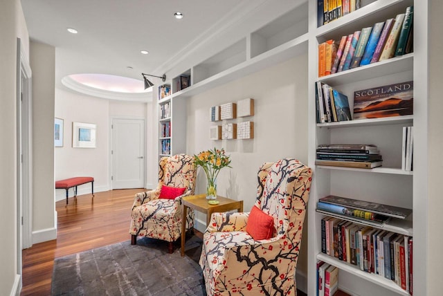 living area with recessed lighting, baseboards, and wood finished floors