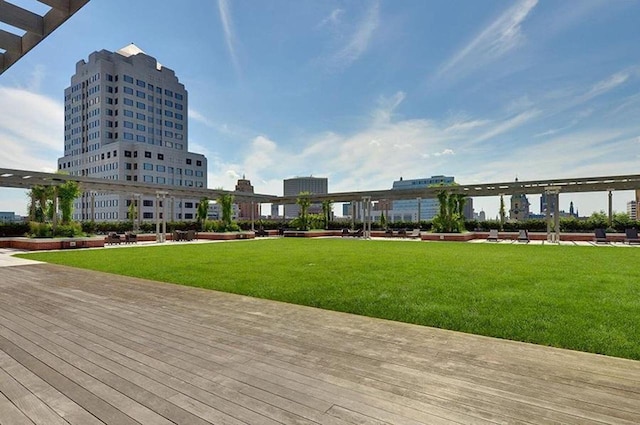 exterior space with a city view and a lawn