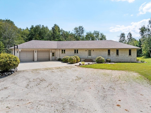 ranch-style home with a garage and a front lawn