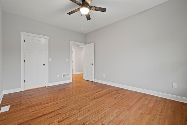 empty room with ceiling fan and light hardwood / wood-style floors