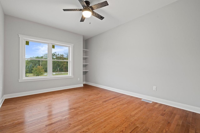 empty room featuring ceiling fan and light hardwood / wood-style flooring