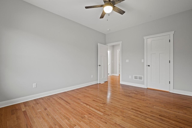 empty room featuring light wood-type flooring and ceiling fan