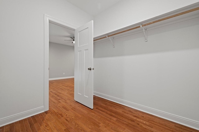 spacious closet featuring hardwood / wood-style floors and ceiling fan