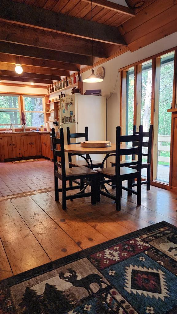 N697 County Rd N, Neshkoro, WI 54960 - dining room with beam ceiling, healthy amount of natural light, light wood-style flooring, and wooden ceiling