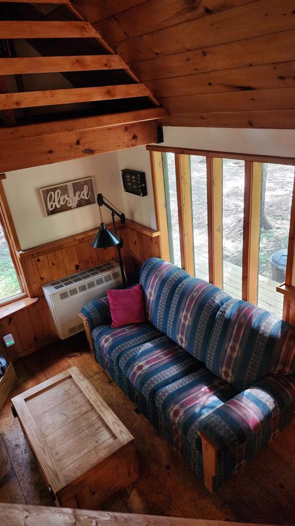 N697 County Rd N, Neshkoro, WI 54960 - living room with lofted ceiling, hardwood / wood-style floors, wood ceiling, and a wall mounted air conditioner