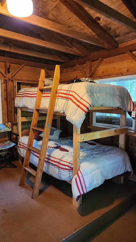 N697 County Rd N, Neshkoro, WI 54960 - bedroom featuring wood walls, beam ceiling, and wood ceiling