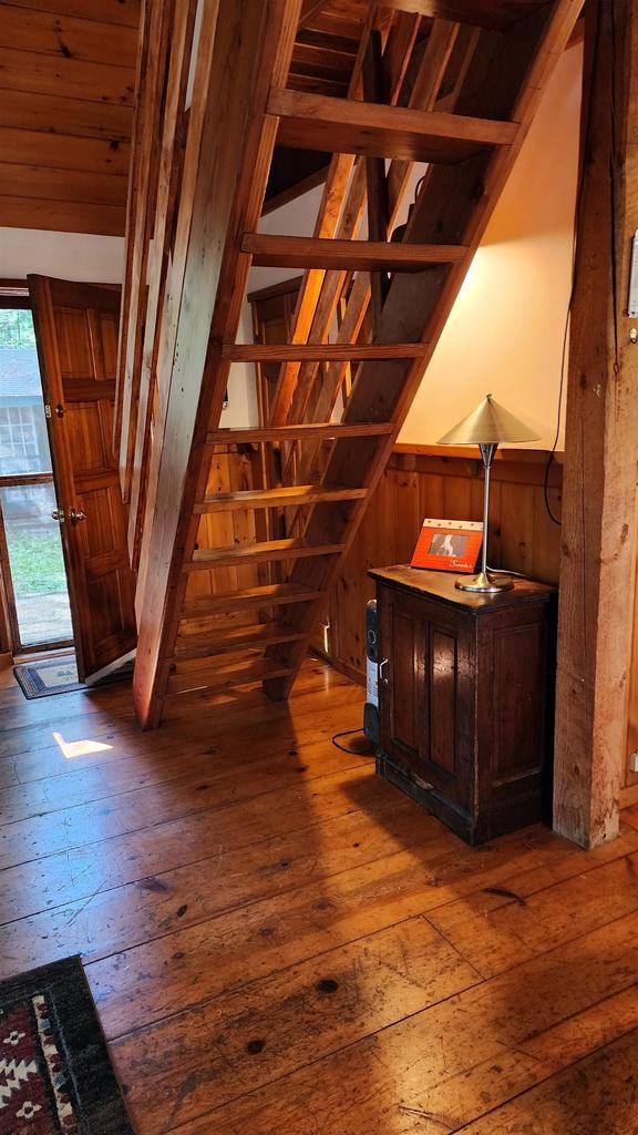 N697 County Rd N, Neshkoro, WI 54960 - staircase featuring hardwood / wood-style floors and wood walls