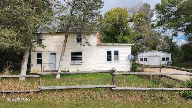 N697 County Rd N, Neshkoro, WI 54960 - view of front of house with a garage, fence, driveway, and an outdoor structure