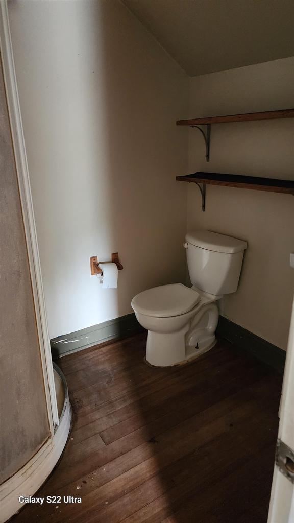 N697 County Rd N, Neshkoro, WI 54960 - bathroom with toilet, wood-type flooring, baseboards, and vaulted ceiling