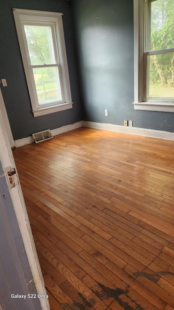 N697 County Rd N, Neshkoro, WI 54960 - empty room with hardwood / wood-style floors, healthy amount of natural light, and baseboards