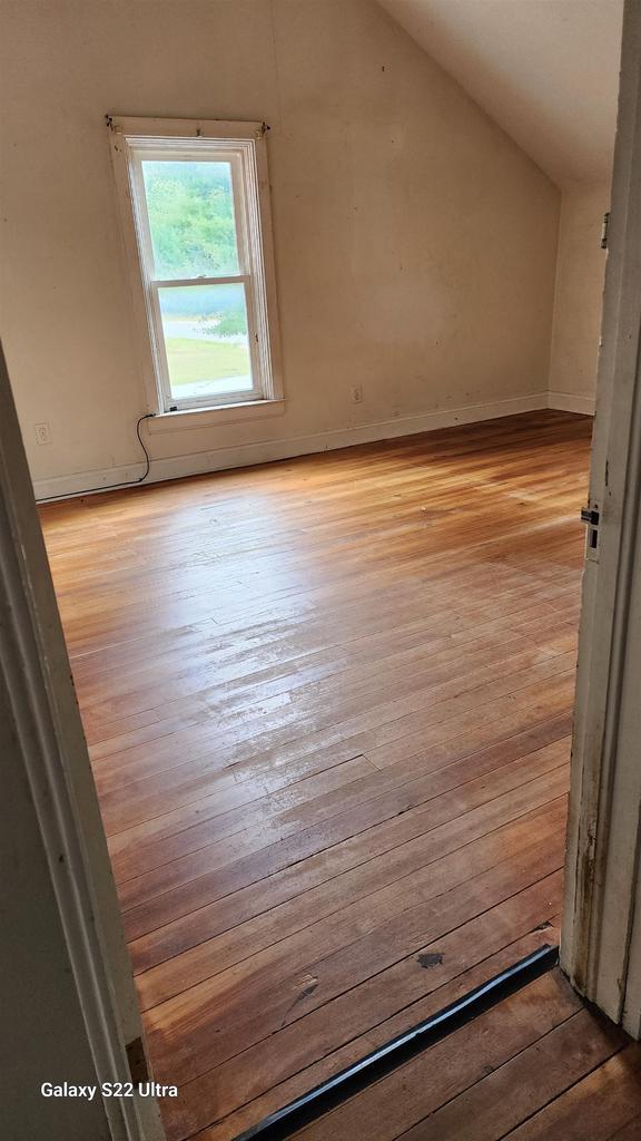 N697 County Rd N, Neshkoro, WI 54960 - additional living space featuring light wood-style flooring, vaulted ceiling, and baseboards