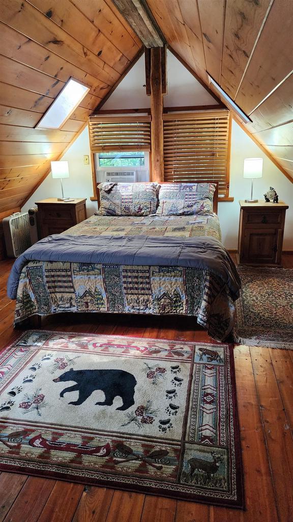 N697 County Rd N, Neshkoro, WI 54960 - bedroom featuring a skylight, vaulted ceiling, wood-type flooring, wooden ceiling, and cooling unit
