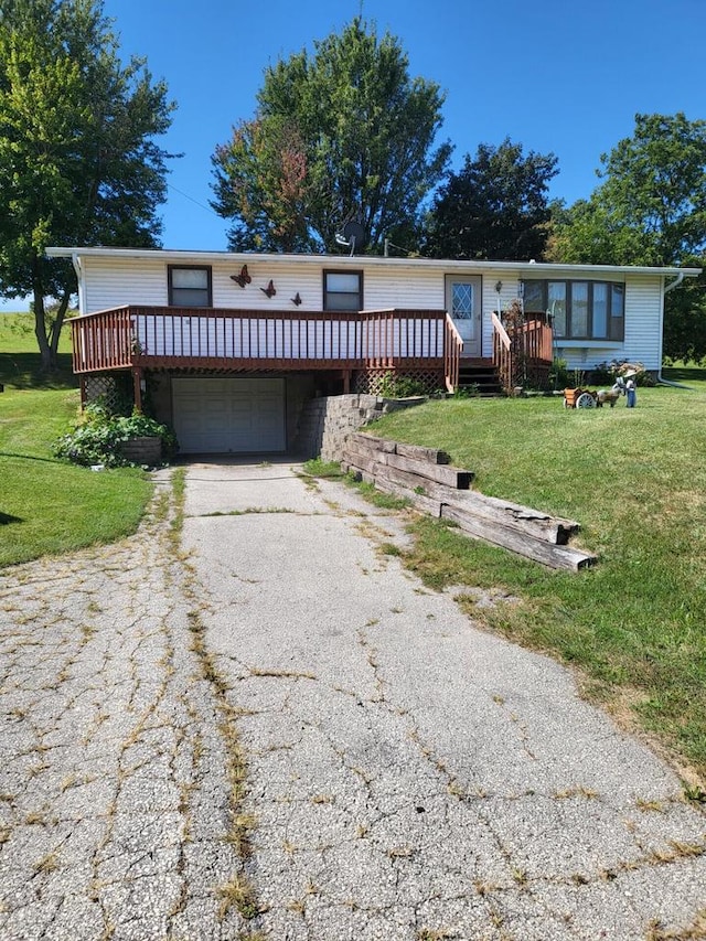 view of front of property featuring a garage, a deck, and a front lawn