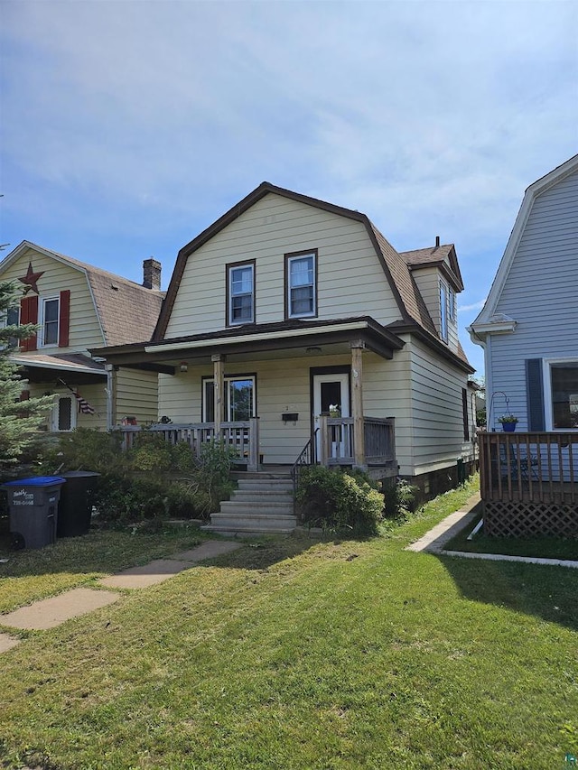 bungalow-style home with covered porch and a front yard