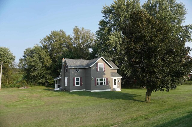 view of side of home featuring a lawn