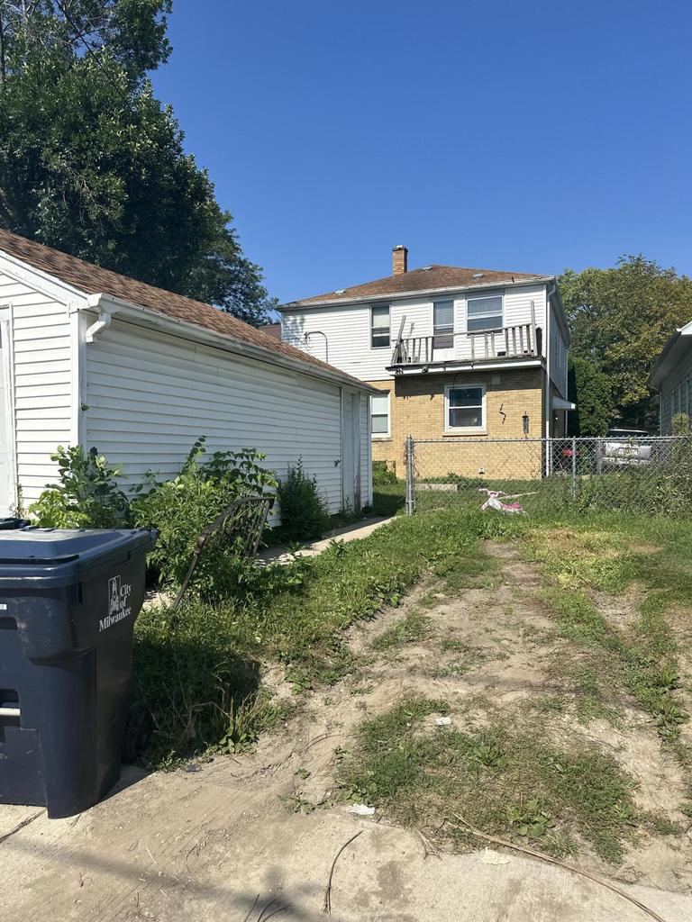 back of property featuring a balcony