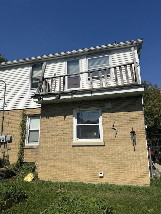 view of side of home featuring a balcony