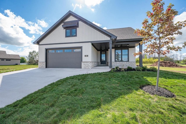 modern farmhouse style home with stone siding, concrete driveway, a front yard, a shingled roof, and a garage