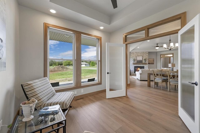 1629 N Honeysuckle Cir, De Pere, WI 54115 - doorway to outside featuring ceiling fan with notable chandelier, recessed lighting, light wood-style flooring, and baseboards