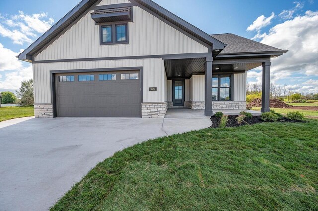1629 N Honeysuckle Cir, De Pere, WI 54115 - modern farmhouse style home with stone siding, a front yard, driveway, and a garage