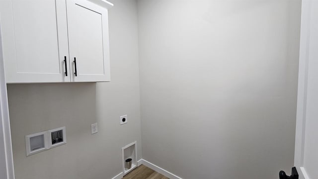 clothes washing area featuring washer hookup, wood finished floors, cabinet space, baseboards, and hookup for an electric dryer