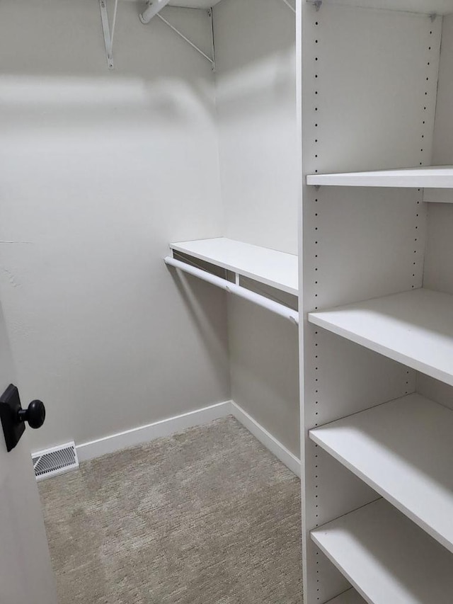 spacious closet with visible vents and carpet