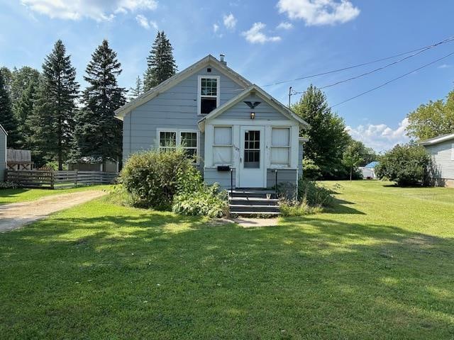 back of property with a lawn