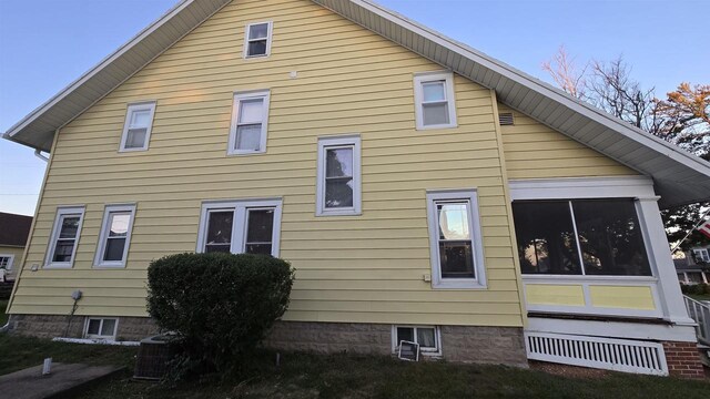 view of side of property with central AC unit